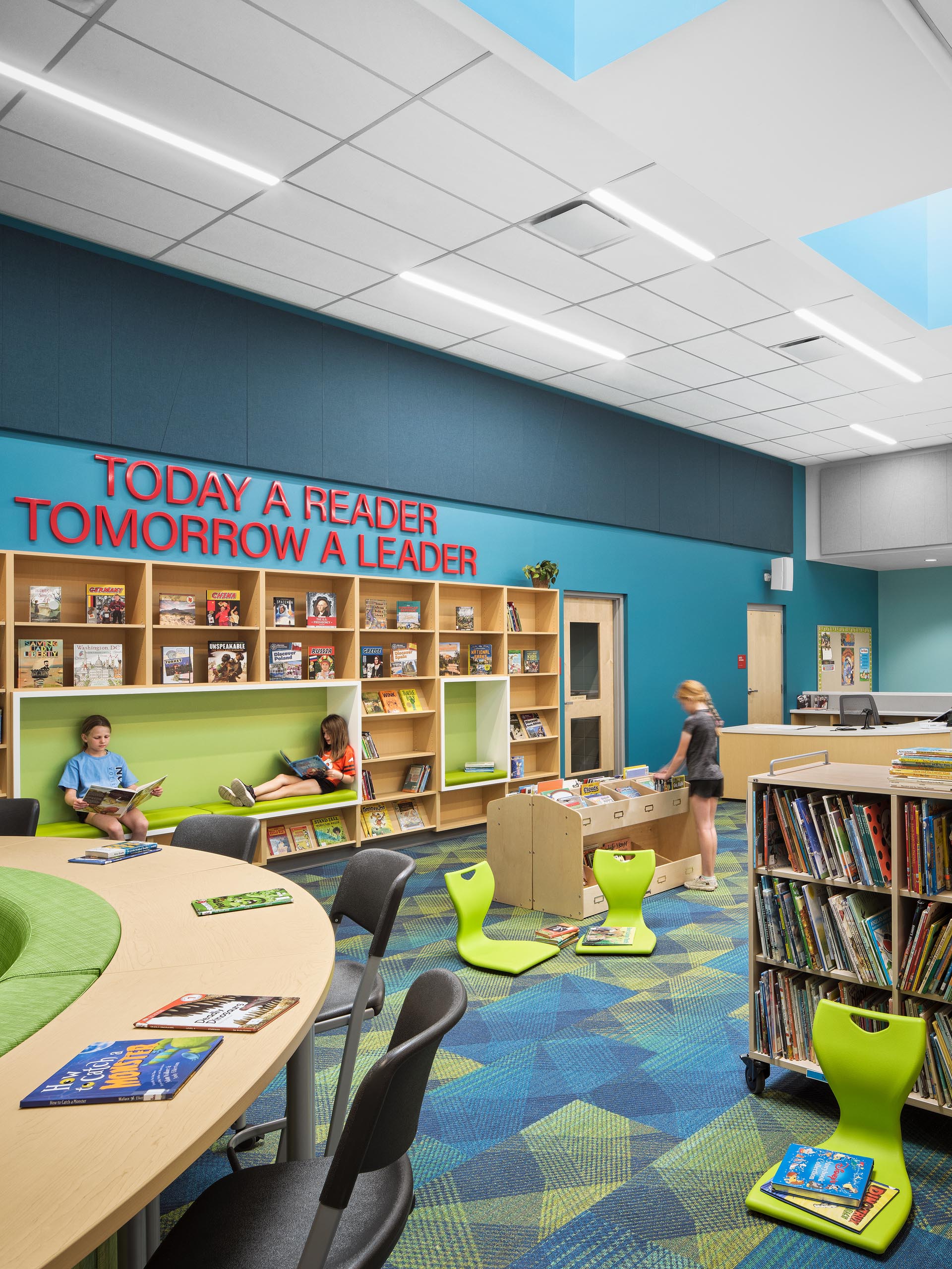 Architectural photography by Warren Diggles. Eaton Elementary students looking through books and reading in media room. K-12 remodel project by RB+B Architects and FCI Constructors.