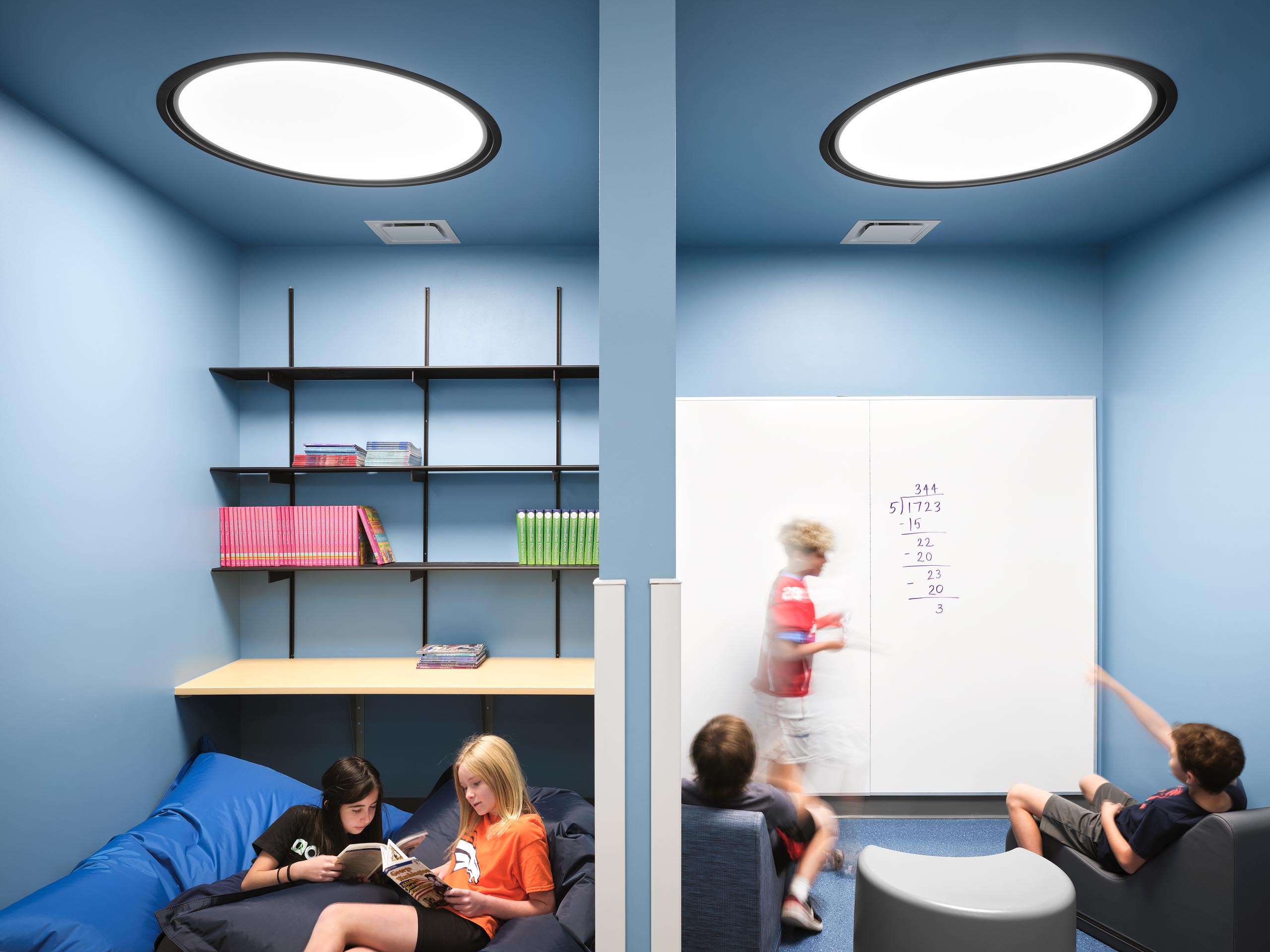 Architectural photography by Warren Diggles. Eaton Elementary students hanging out in built-in nooks. K-12 remodel project by RB+B Architects and FCI Constructors.