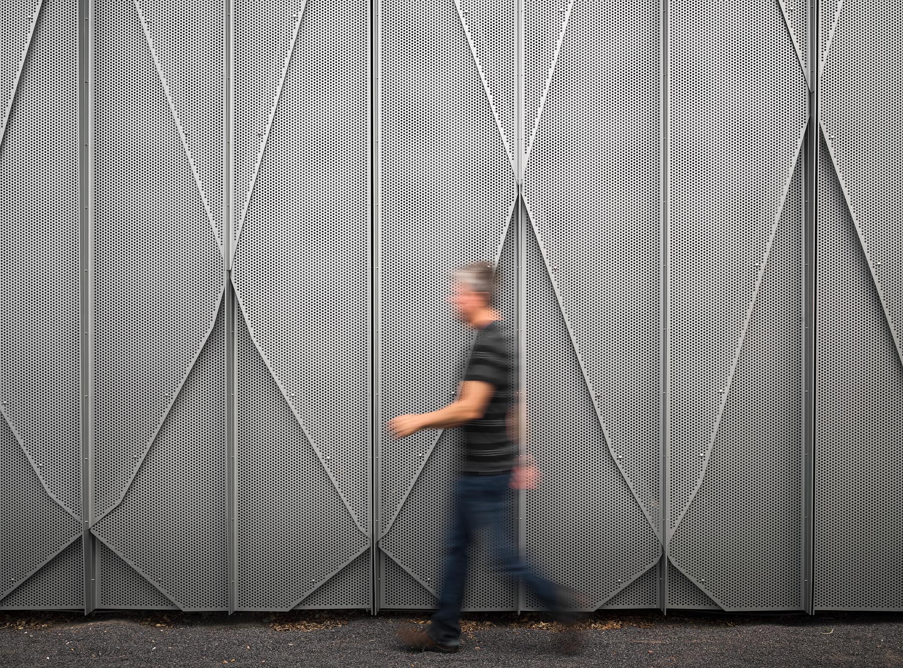 Architectural photography by Warren Diggles. SITE Santa Fe's folded, perforated aluminum exterior system. Renovation and expansion project by SHoP Architects.